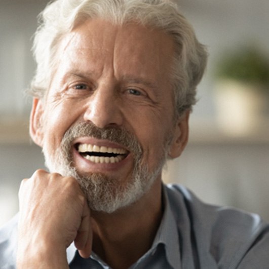 Man wearing dentures and smiling