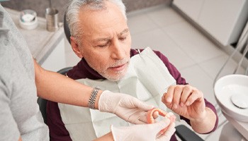 Man getting dentures in the dental chair