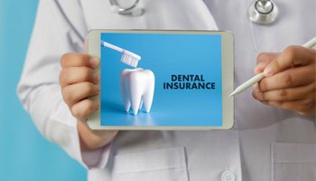 Doctor holding tablet with dental insurance information