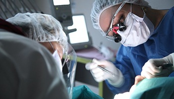 an oral surgeon performing dental implant placement