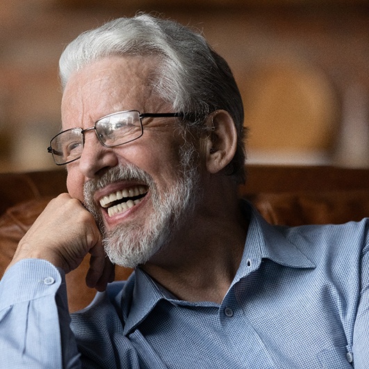 Senior woman laughing at dinner table