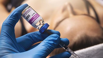 Gloved hand preparing a BOTOX injection