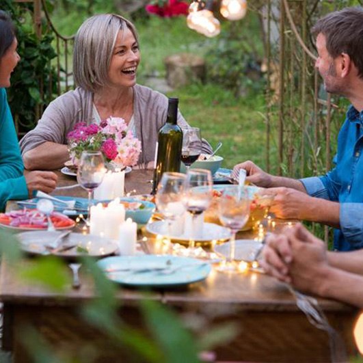 Woman smiling with dental bridge in Barnegat at dinner party