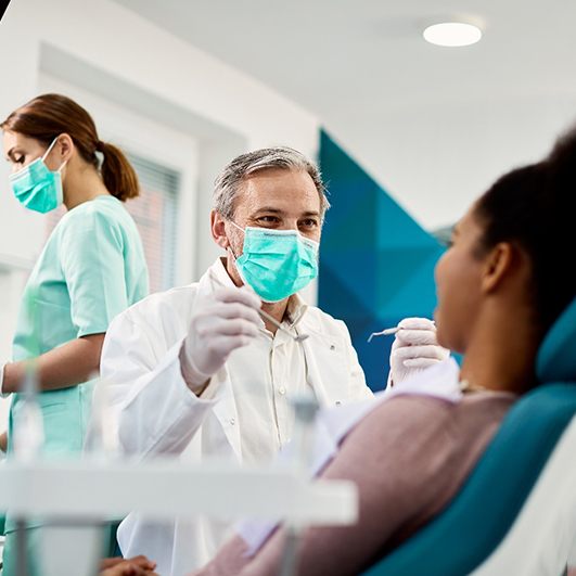 a dentist performing a dental checkup and cleaning in Barnegat