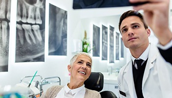 Dentist and patient looking at X-ray together