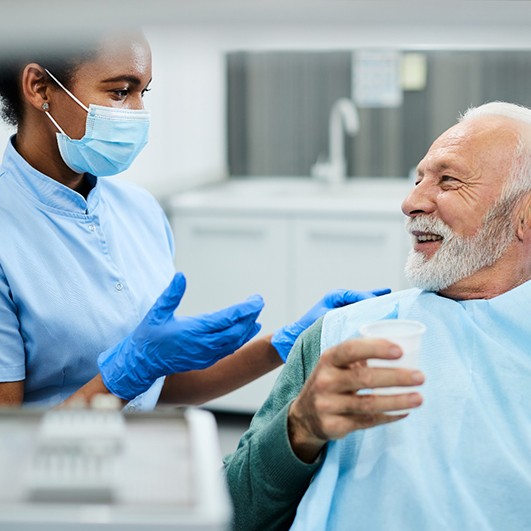 a dentist explaining the cost of dentures to a patient