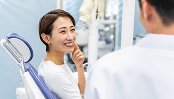 a patient talking to her dentist about cost of dentures