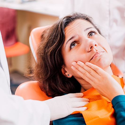 Woman with toothache visiting her Barnegat emergency dentist 