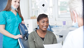 Dentist and patient discussing paying for emergency dental care in Barnegat