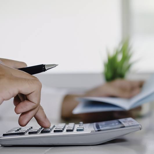 Man calculating cost of tooth extraction in Barnegat