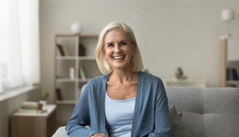 a woman smiling with her new dental implants