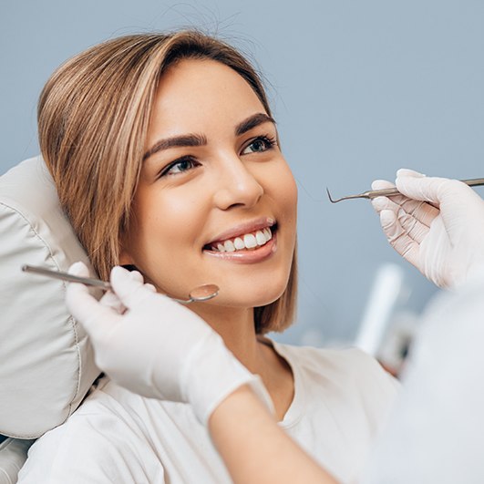 Woman smiling during dental treatment