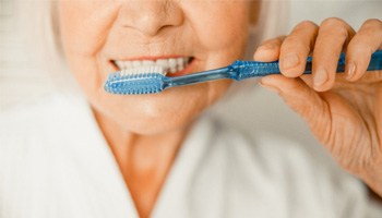 closeup of woman brushing teeth 