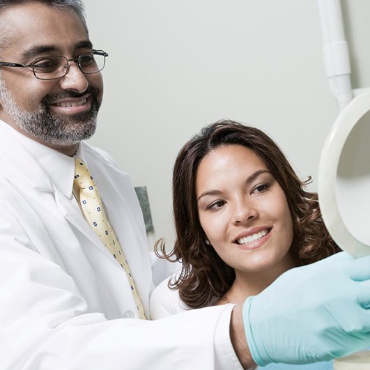 Woman meeting with dentist in Barnegat