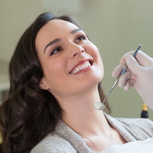 Patient smiling during preventive dentistry exam