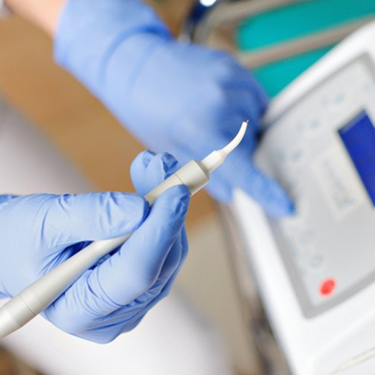 Dentist holding a soft tissue laser