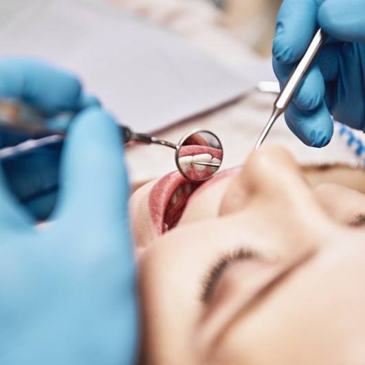 Dentist examining a patient’s teeth