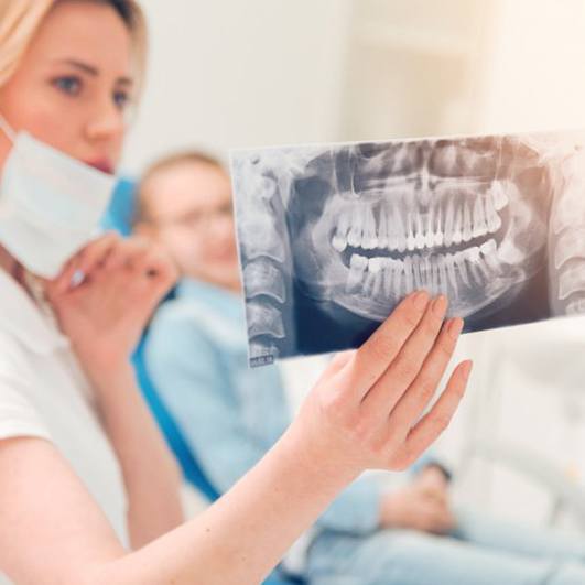 Dentist looking at a patient’s X-ray