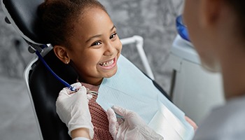 Child in Barnegat smiling after dental sealant appointment