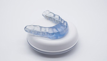Occlusal splint for TMD shown against neutral background