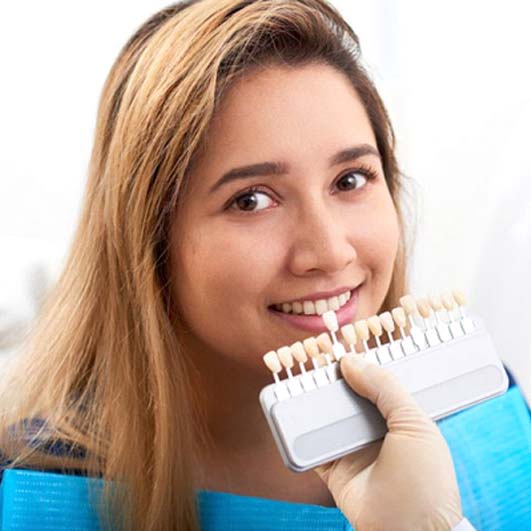 young woman trying on veneers in Barnegat