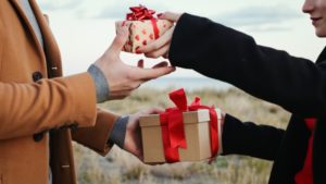 happy couple exchanging Valentine’s Day gifts