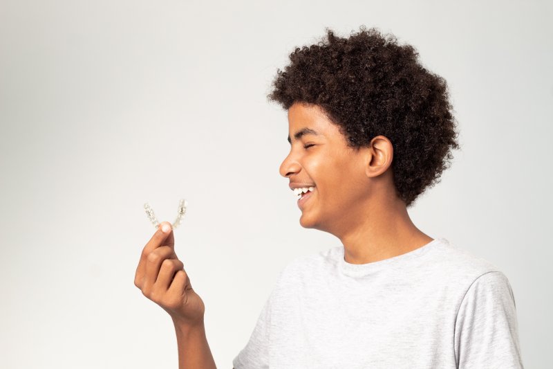 A young man trying to get his NU Smile Aligner to fit