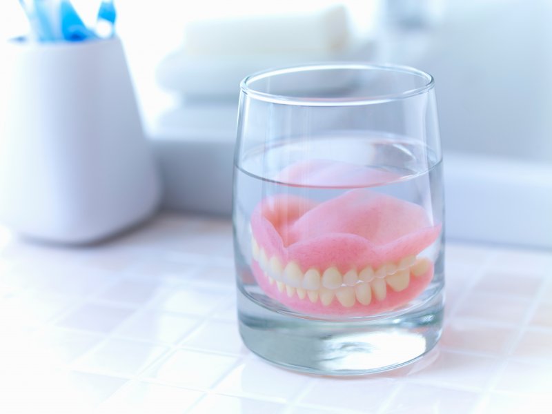 A denture soaking on a counter