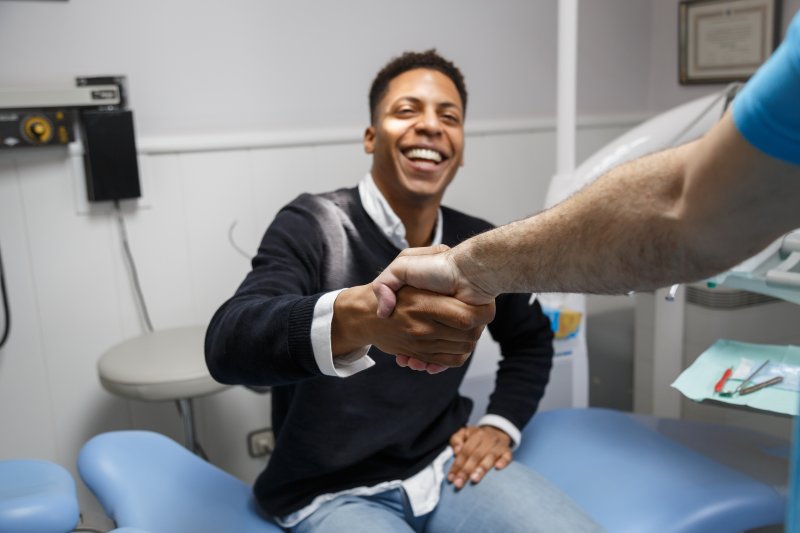 Patient smiling after getting cosmetic dentistry