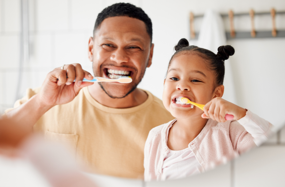 Dad and daughter brushing teeth